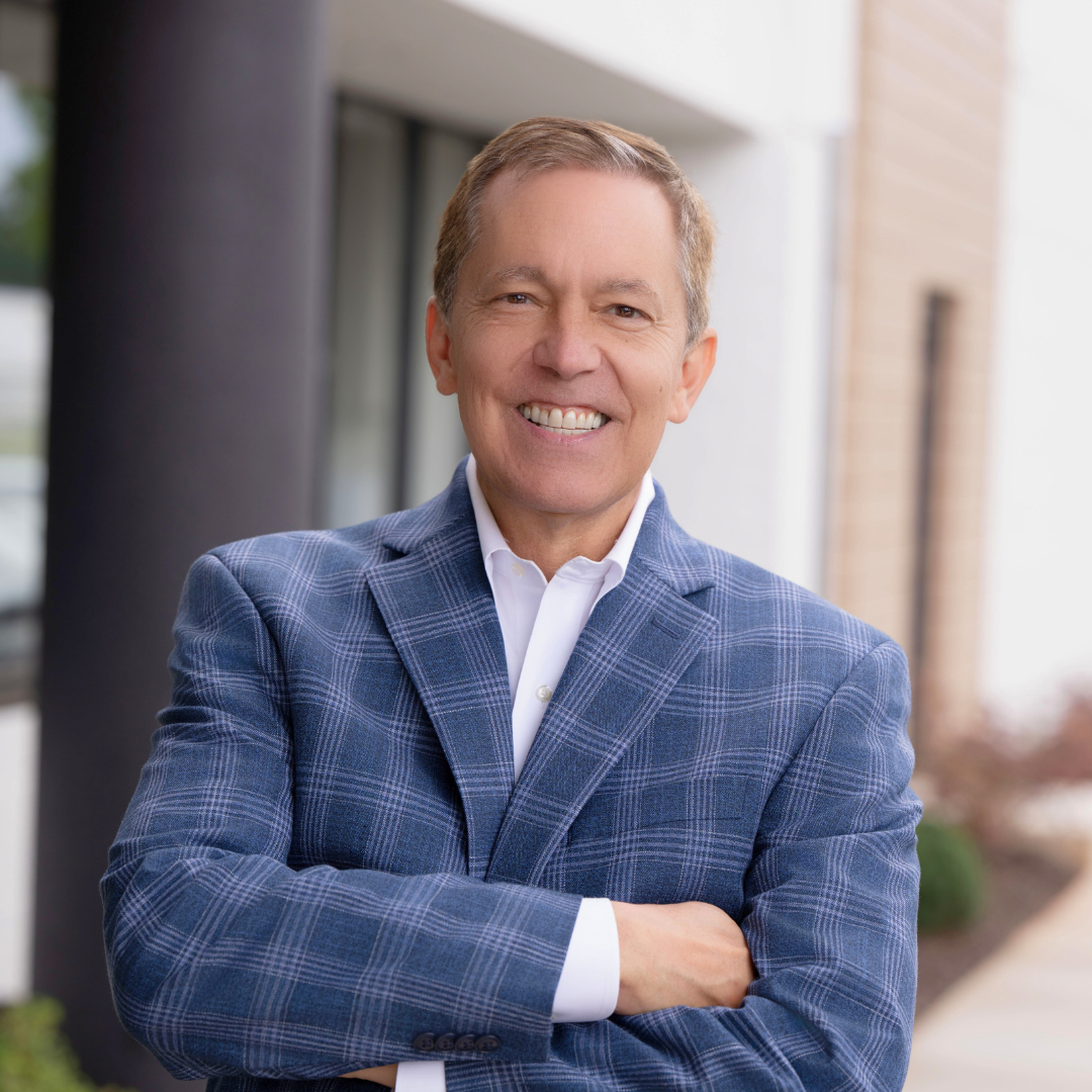 Matthew Pieper, CEO, stands in front of Open Hand with a wide smile and arms casually crossed.